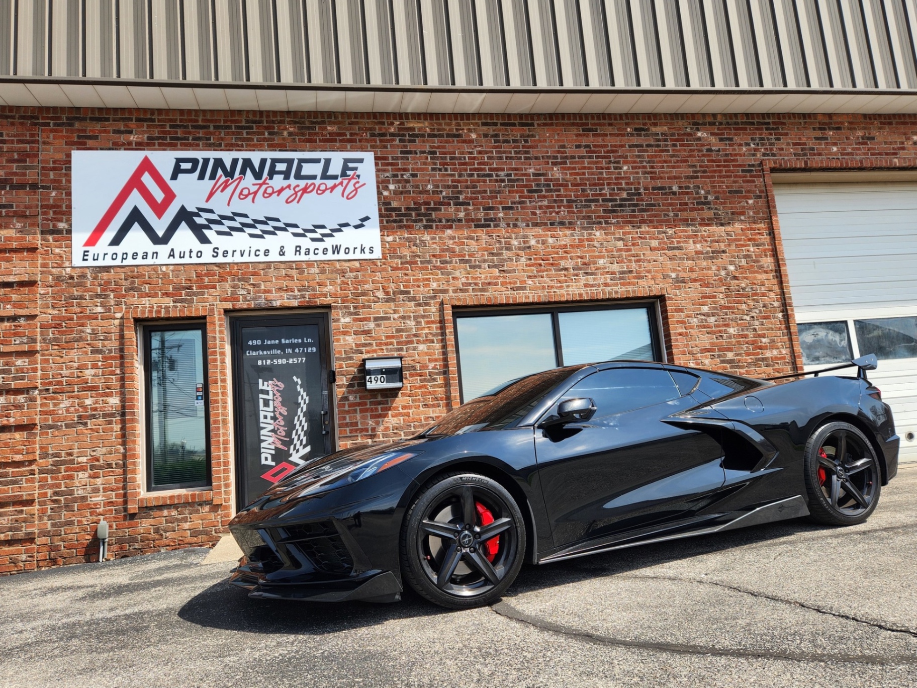 Black Chevrolet Corvette C8 Z06 at the shop entrance